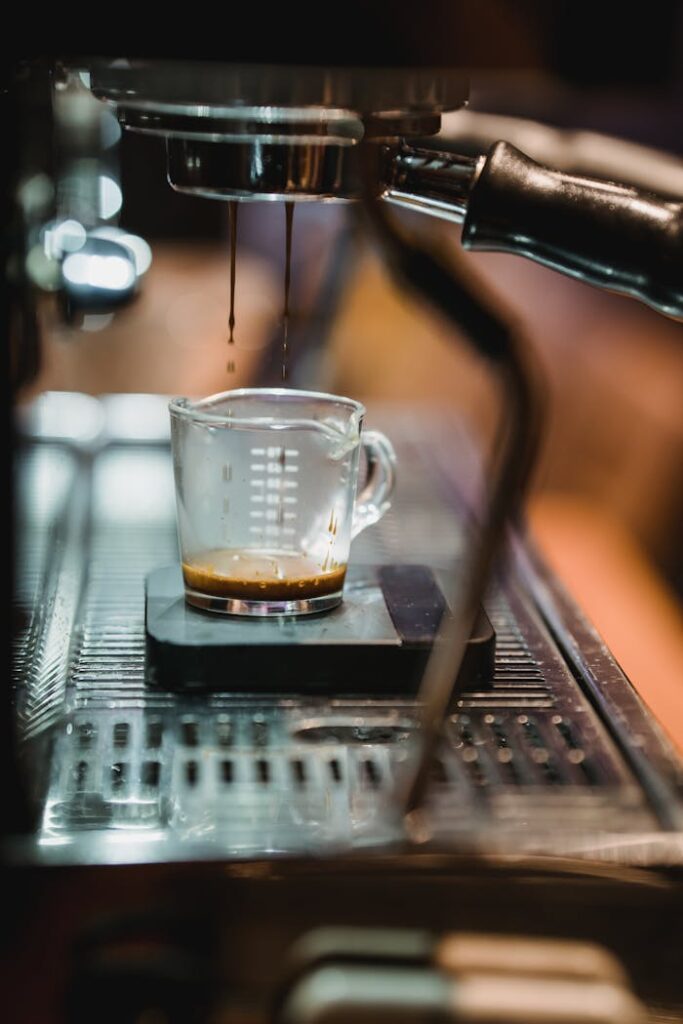 Close-up of espresso shot being prepared in a café's coffee machine.